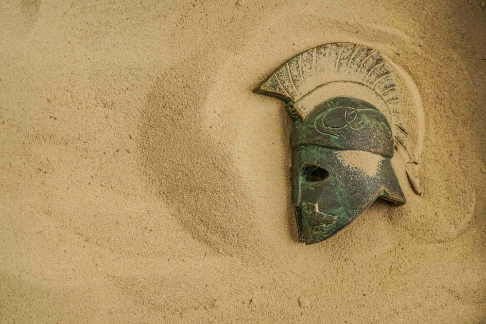 helmet,of,ancient,warriors,in,sand.,roman,legionar's,helmet,with