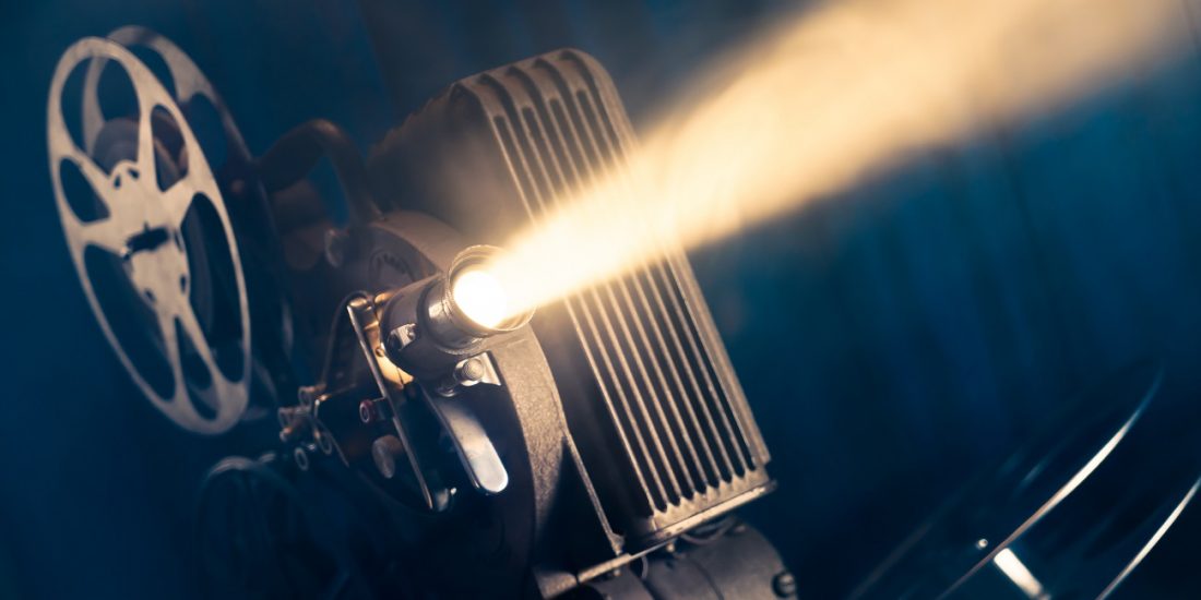 film,projector,on,a,wooden,background,with,dramatic,lighting,and