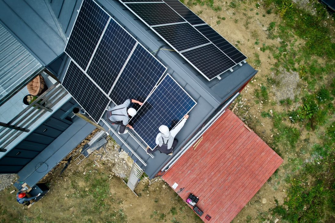 installers,building,photovoltaic,solar,module,station,on,roof,of,house.