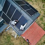 installers,building,photovoltaic,solar,module,station,on,roof,of,house.